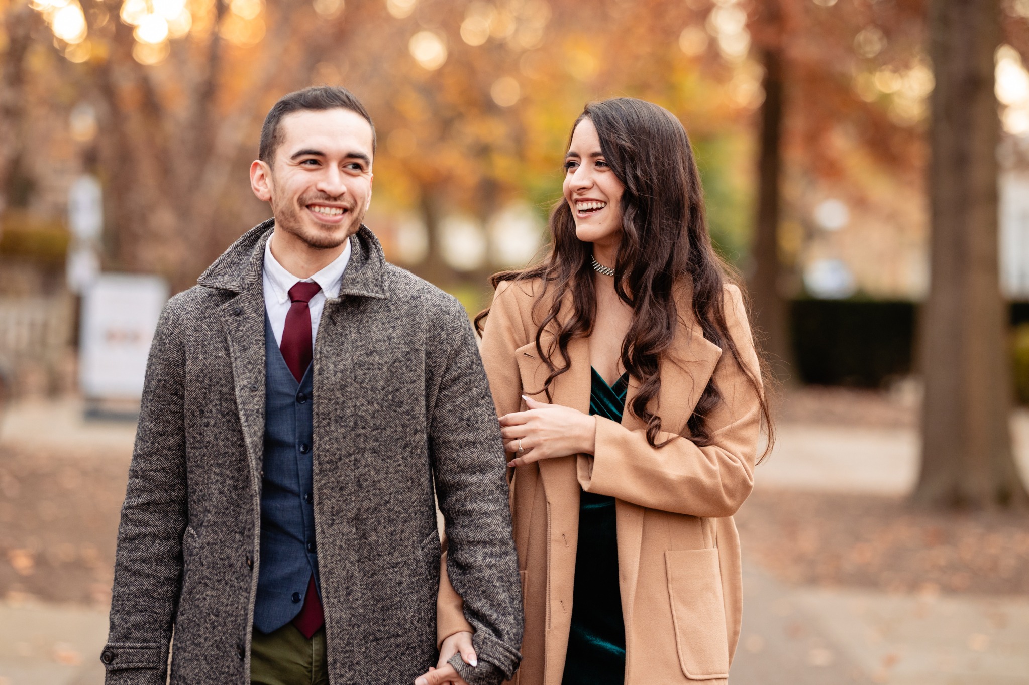 Briana and Israel laughing together on an autumn afternoon